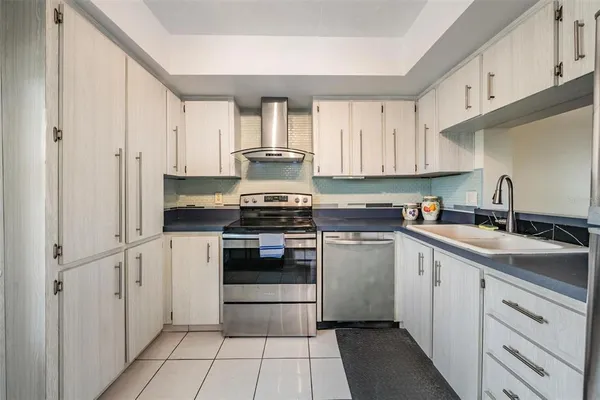 a kitchen with a table chairs and a sink