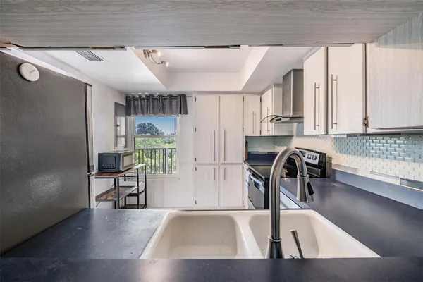 a bedroom with a bed dresser and a window