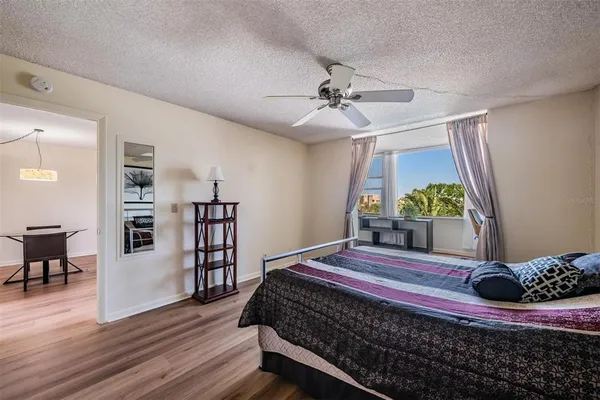 a spacious bedroom with a bed and a window