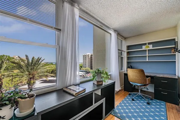 a workspace with furniture and window