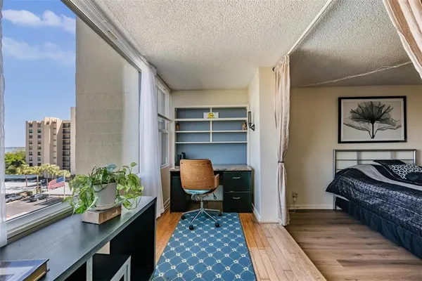 a view of empty room with wooden floor and fireplace