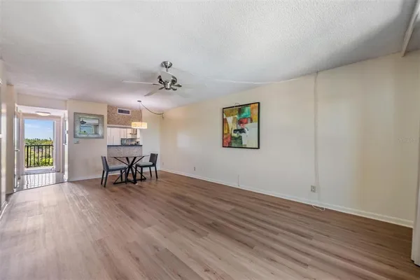 a view of a livingroom with furniture wooden floor and a window