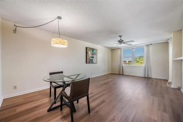a view of a dining room with furniture and wooden floor