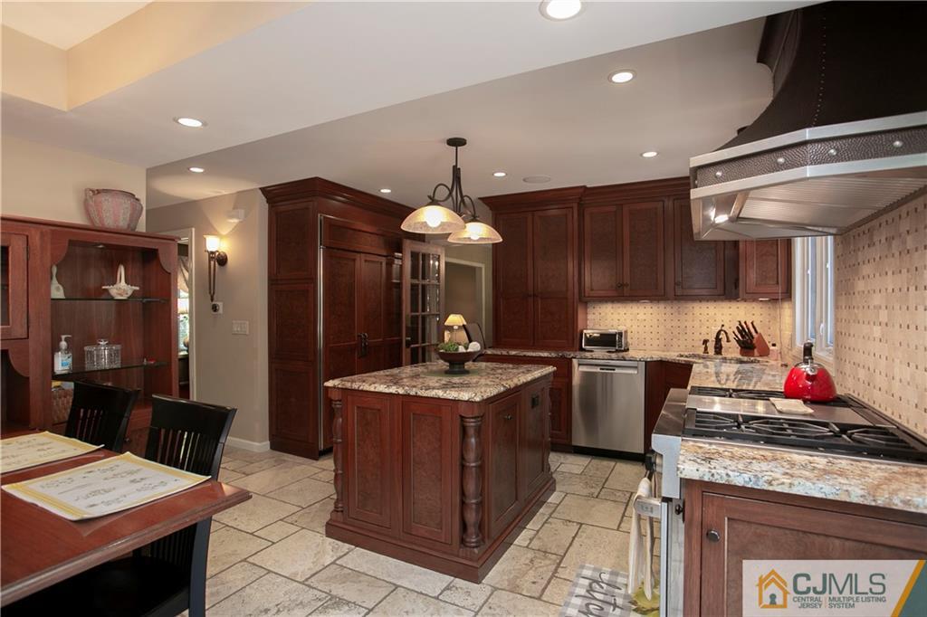 36 Pine Ridge Drive Edison, NJ 08820 - Photo 11 of 51 a kitchen with stainless steel appliances granite countertop a stove a sink and a refrigerator