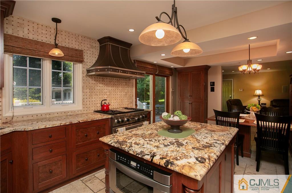 36 Pine Ridge Drive Edison, NJ 08820 - Photo 13 of 51 a kitchen with granite countertop a sink a counter top space and stainless steel appliances