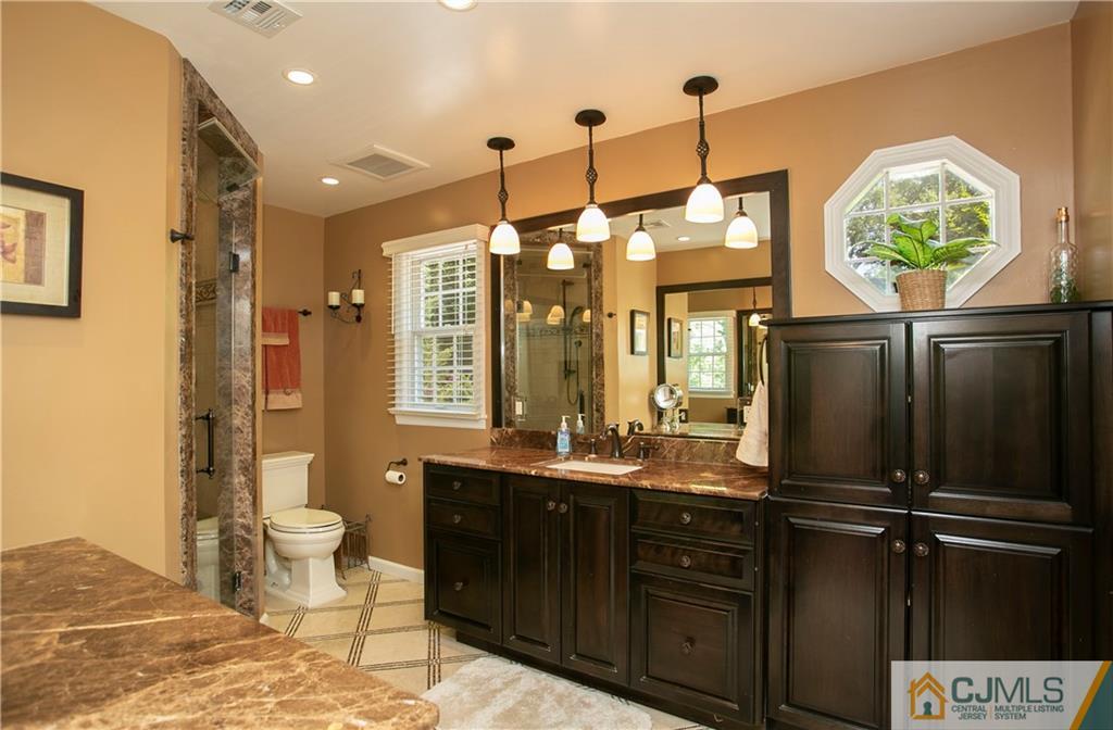 36 Pine Ridge Drive Edison, NJ 08820 - Photo 23 of 51 a bathroom with a sink a toilet and a shower