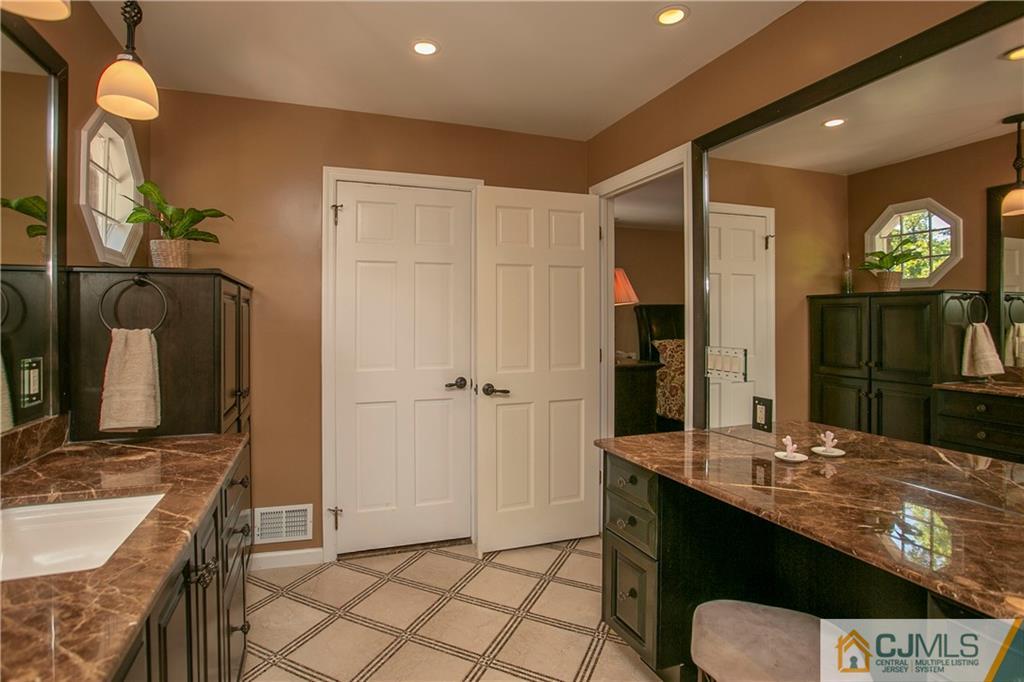 36 Pine Ridge Drive Edison, NJ 08820 - Photo 24 of 51 a bathroom with a sink a toilet and a mirror