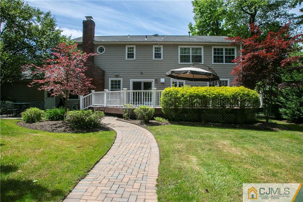36 Pine Ridge Drive Edison, NJ 08820 - Photo 38 of 51 a front view of a house with a garden