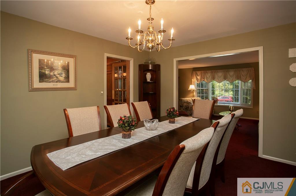 36 Pine Ridge Drive Edison, NJ 08820 - Photo 9 of 51 a view of a dining room with furniture and a chandelier