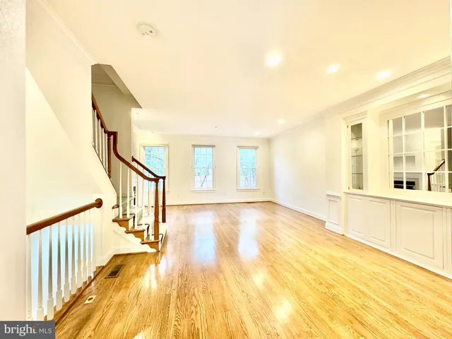 a view of a living room with furniture and a kitchen