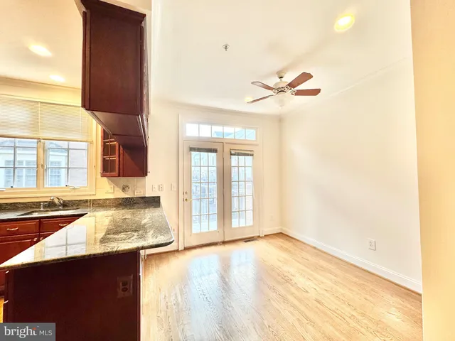 a kitchen with stainless steel appliances kitchen island granite countertop a sink and cabinets