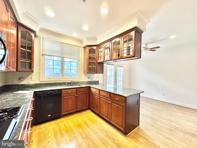 a large white kitchen with a large window