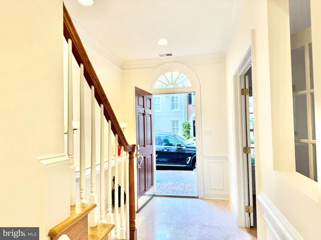 a view of an entryway with wooden floor and windows