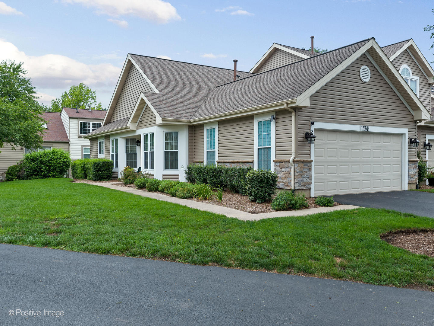 1334 Ridgefield Circle Carol Stream, IL 60188 - Photo 2 of 16 a front view of a house with a garden