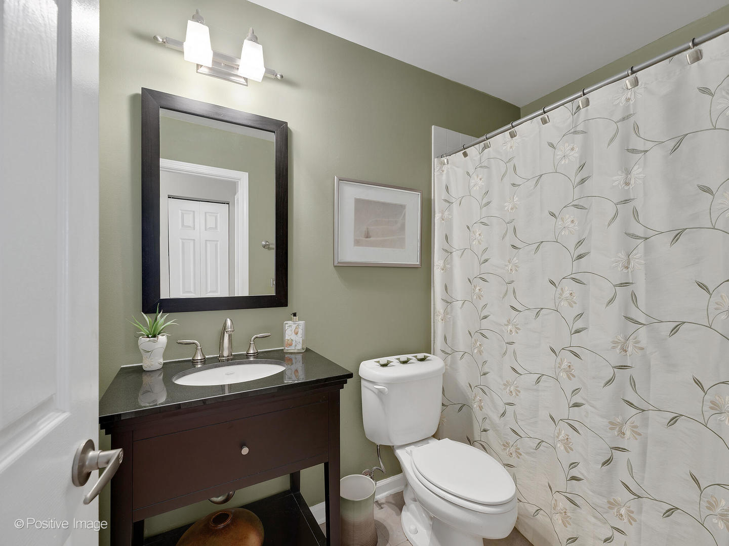 1334 Ridgefield Circle Carol Stream, IL 60188 - Photo 13 of 16 a bathroom with a toilet a sink and a mirror