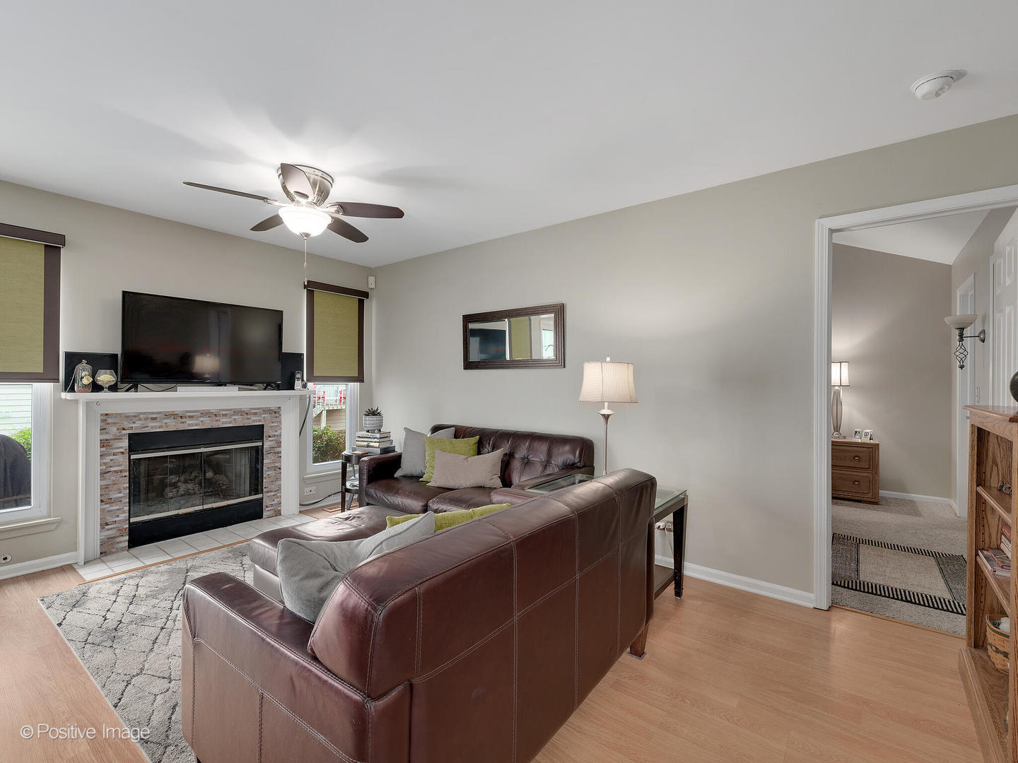 1334 Ridgefield Circle Carol Stream, IL 60188 - Photo 6 of 16 a living room with furniture a fireplace and a flat screen tv