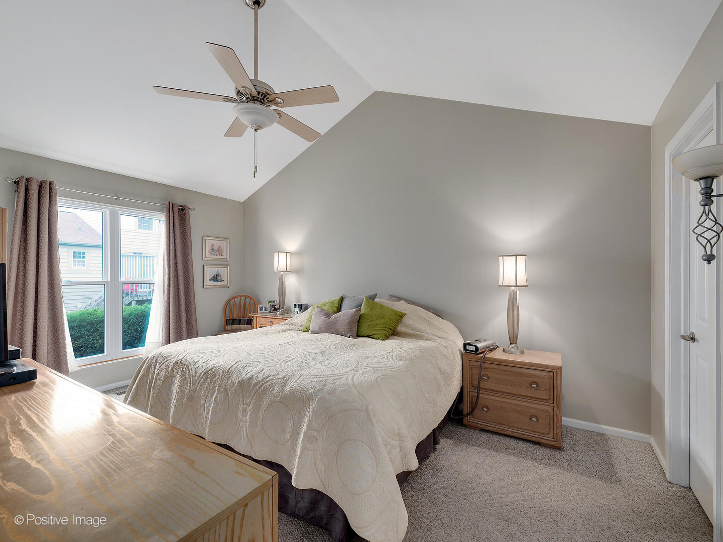 1334 Ridgefield Circle Carol Stream, IL 60188 - Photo 10 of 16 a bedroom with a bed a ceiling fan and a large window