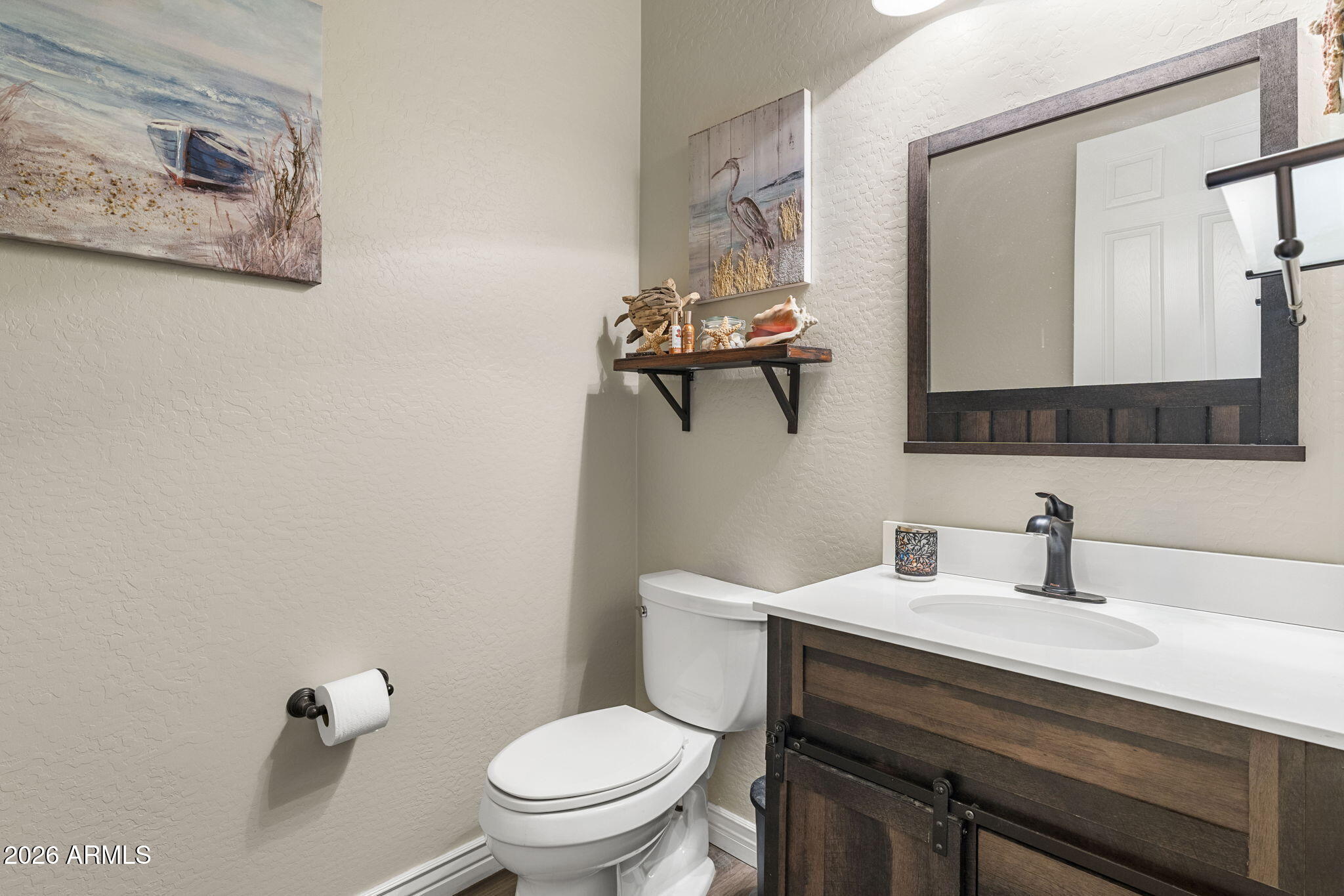 41619 North River Bend Road Anthem, AZ 85086 - Photo 19 of 84 a bathroom with a toilet a sink and mirror