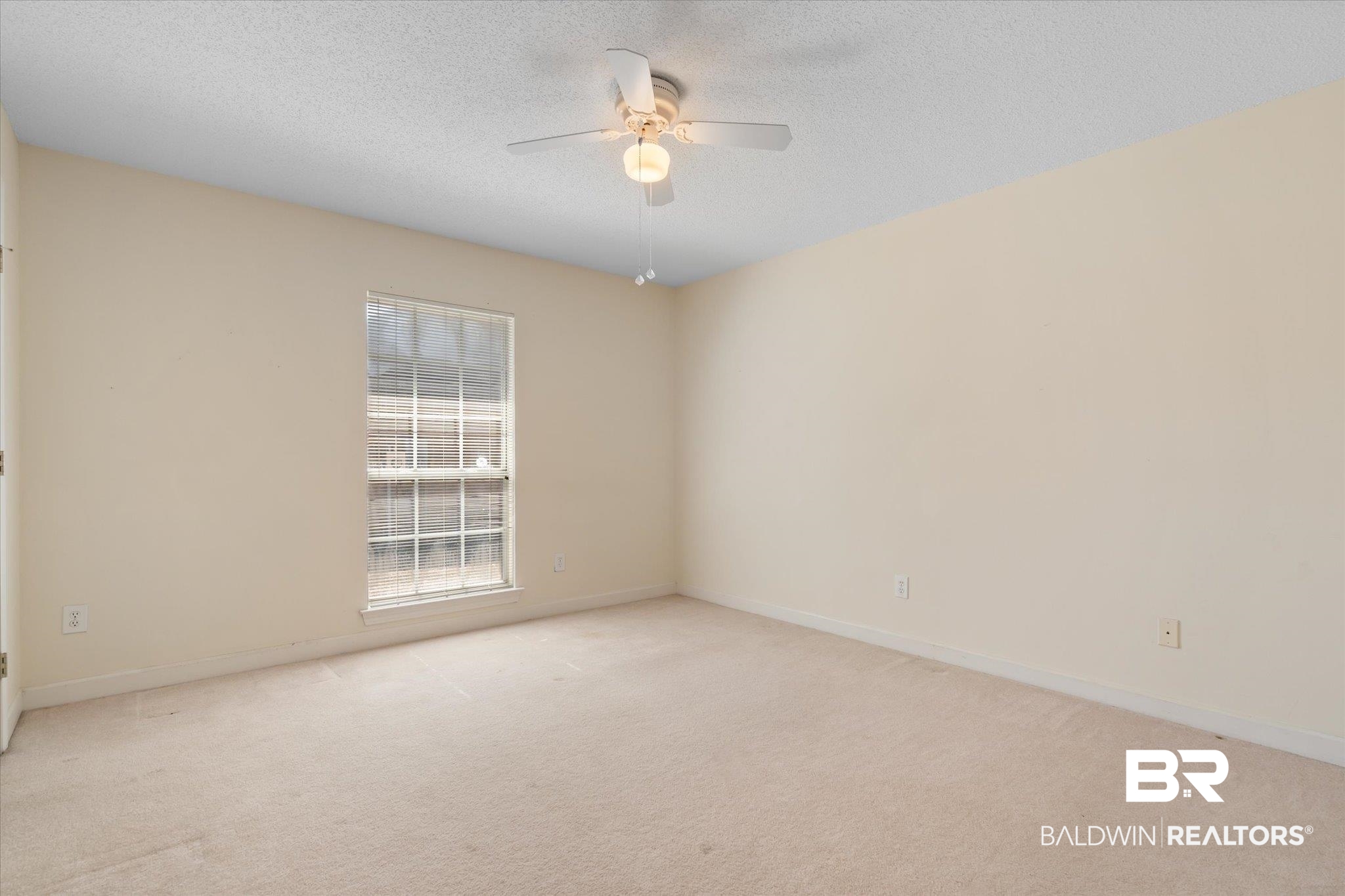 2220 Irongate Court Mobile, AL 36695 - Photo 14 of 20 Spare room featuring light carpet, ceiling fan, a textured ceiling, and baseboards