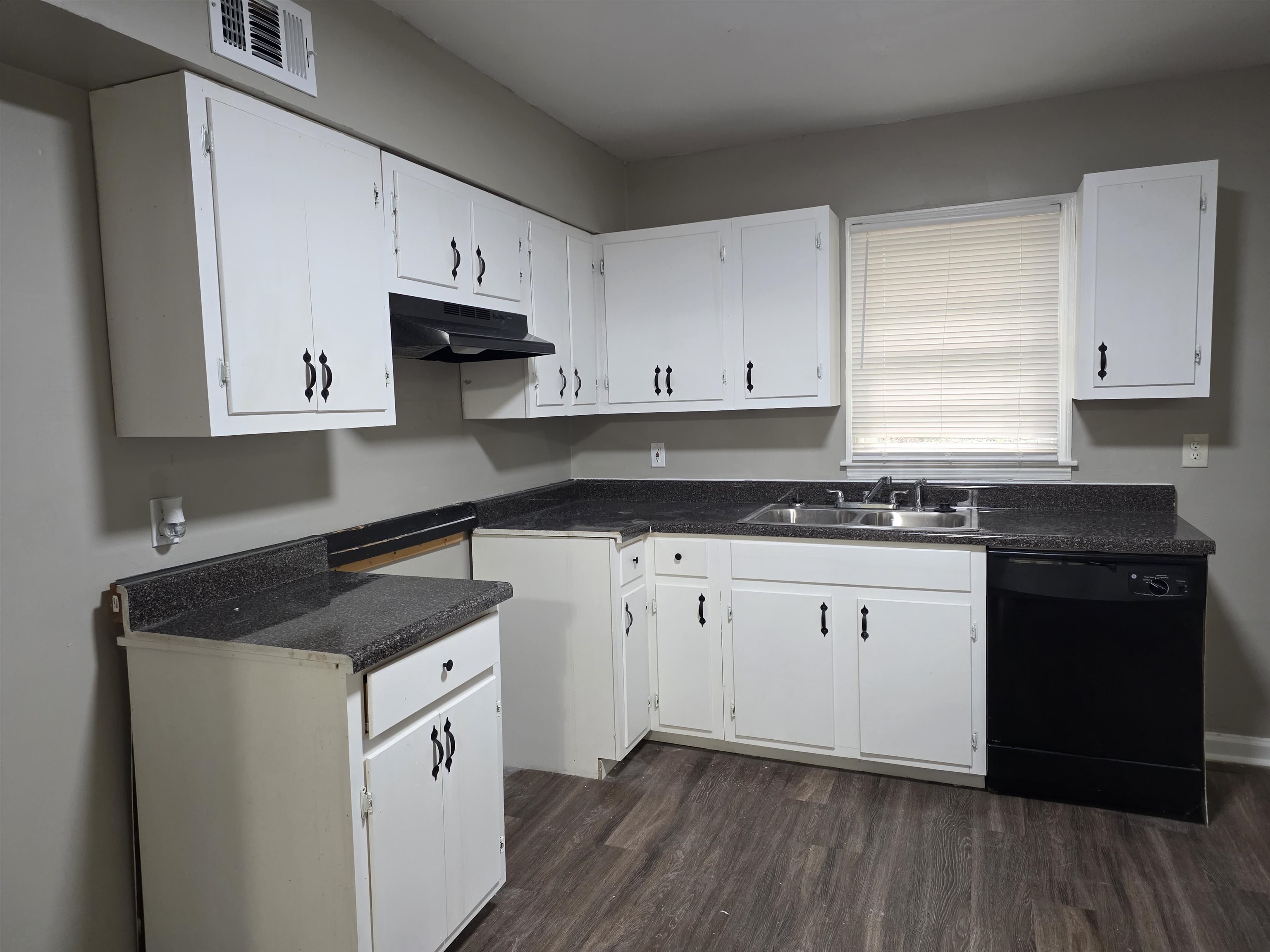 3602 Gowan Drive Memphis, TN 38127 - Photo 13 of 20 a kitchen with granite countertop white cabinets and black appliances