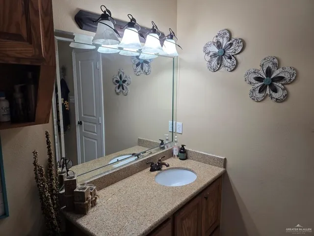 a bathroom with a double vanity sink and a mirror