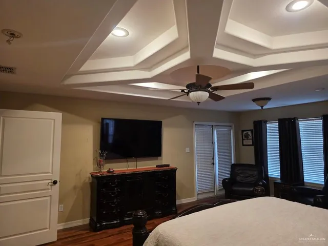 a bedroom with furniture and a flat screen tv