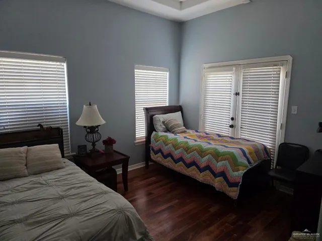 a bedroom with a bed lamp and a window