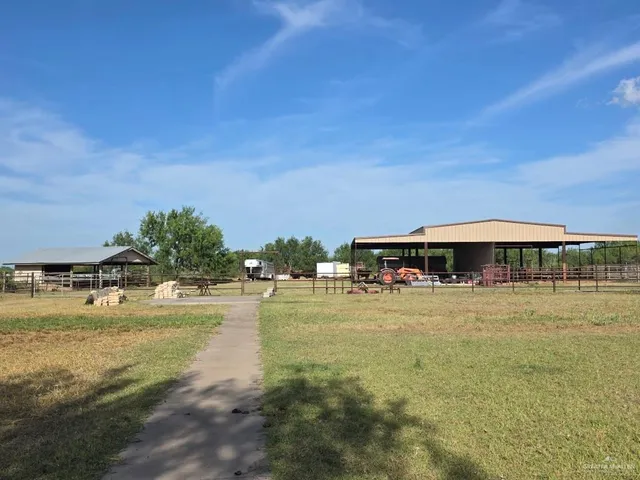 a swimming pool with outdoor seating and yard