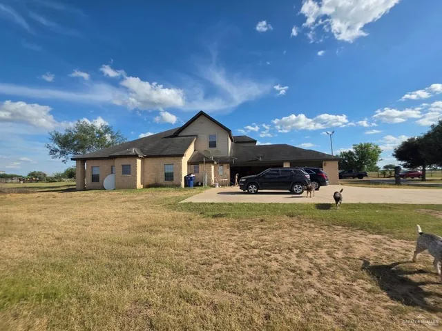 a front view of a house with a big yard