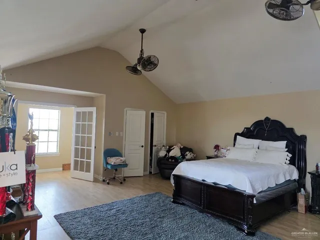 a bedroom with bed and wooden floor