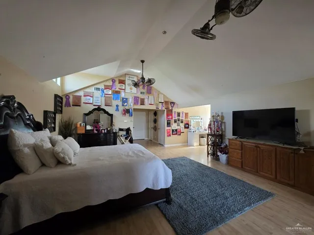 a bedroom with furniture and a flat screen tv