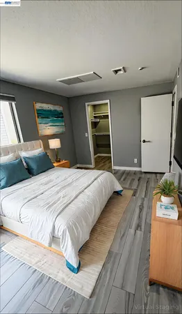 a bedroom with a bed and a large window