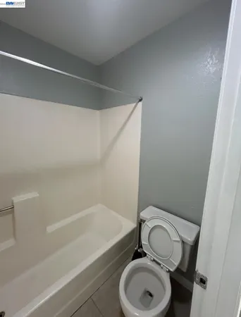 a bathroom with a granite countertop toilet a sink and a bathtub