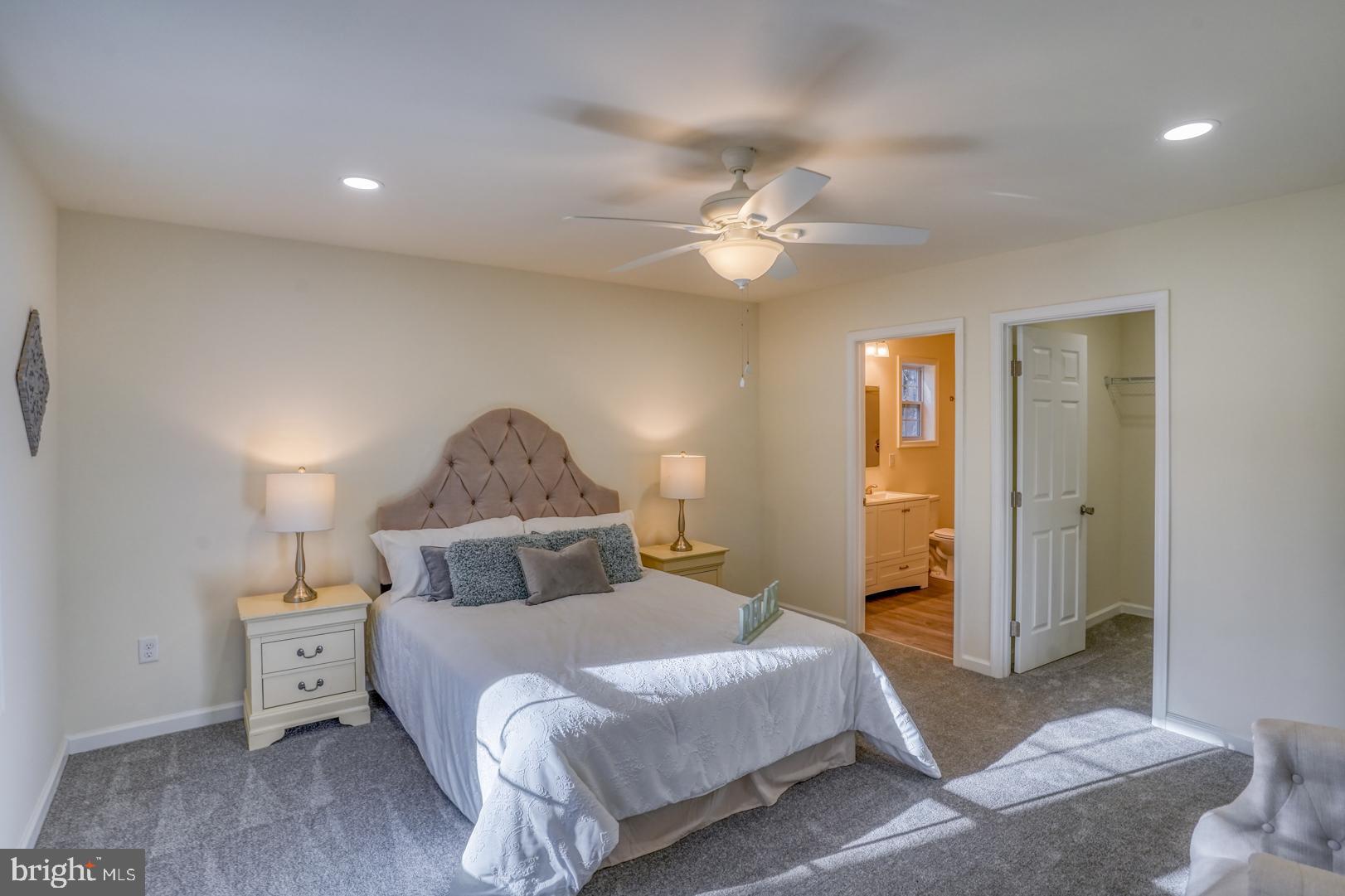 4366 Deep Grass Lane Houston, DE 19954 - Photo 14 of 28 a bedroom with a bed and a chandelier