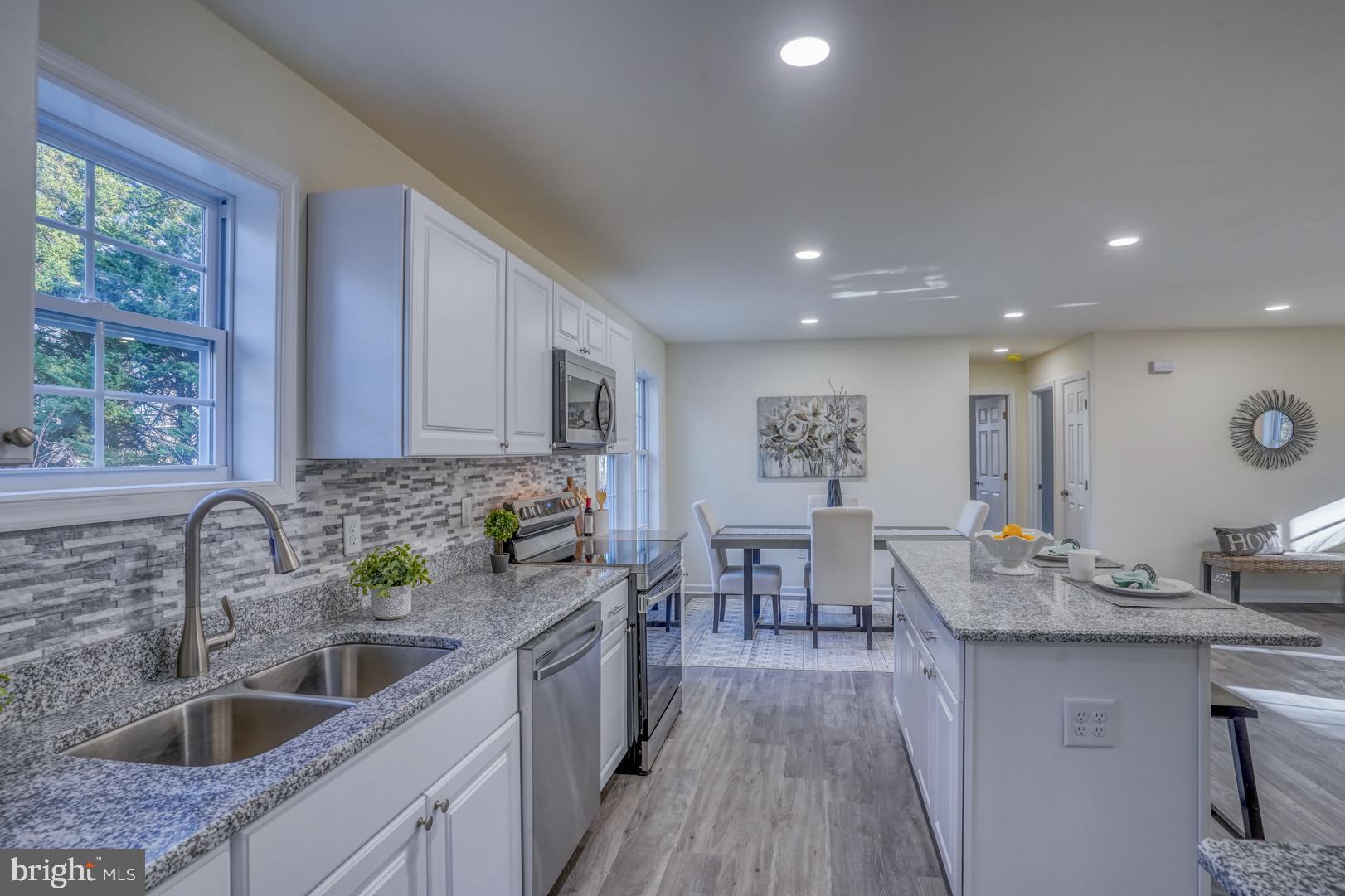 4366 Deep Grass Lane Houston, DE 19954 - Photo 8 of 28 a kitchen with sink a counter top space and living room view