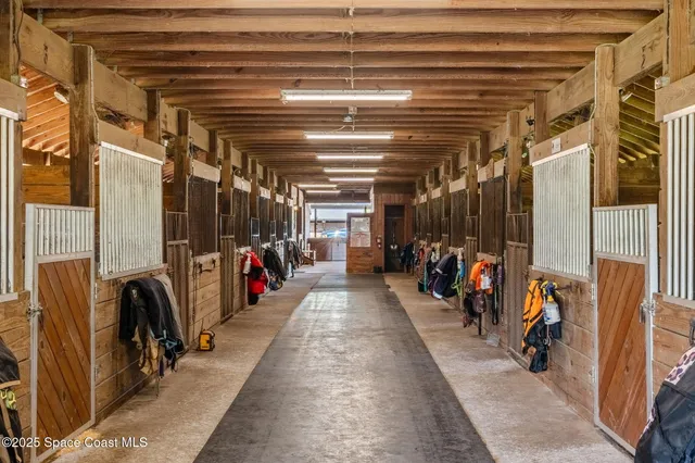 a view of room with wooden floor and windows