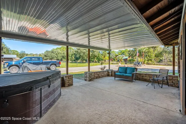 a view of a livingroom with furniture and a flat screen tv