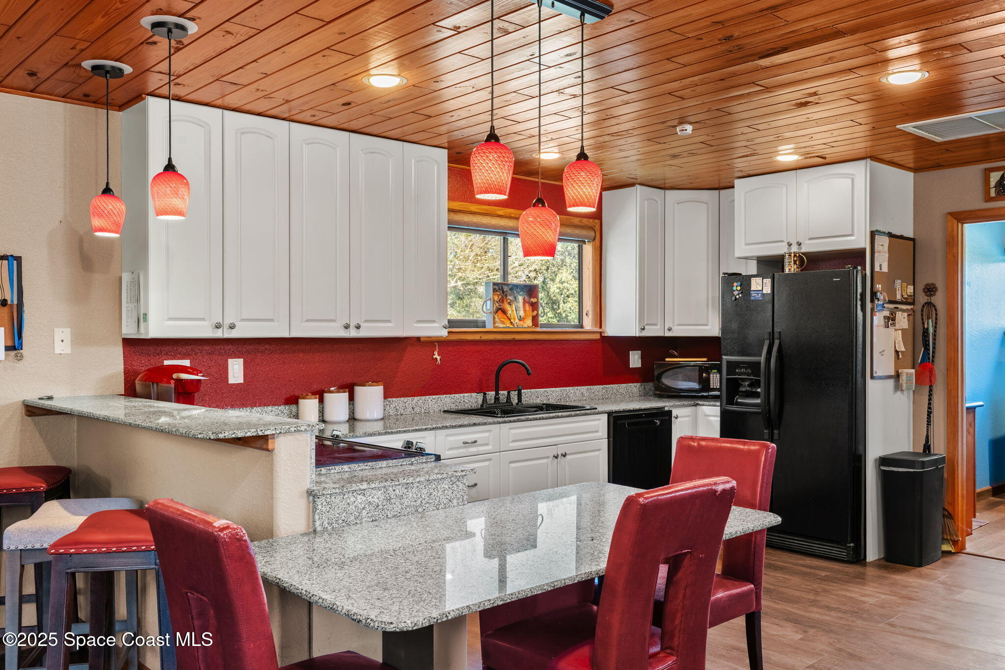 4630 James Road Cocoa, FL 32926 - Photo 36 of 58 a kitchen with stainless steel appliances kitchen island granite countertop a table chairs in it and wooden floors