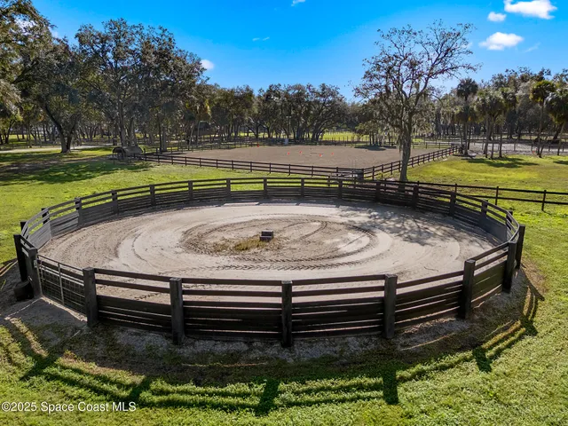 a view of a swimming pool with a yard and sitting area