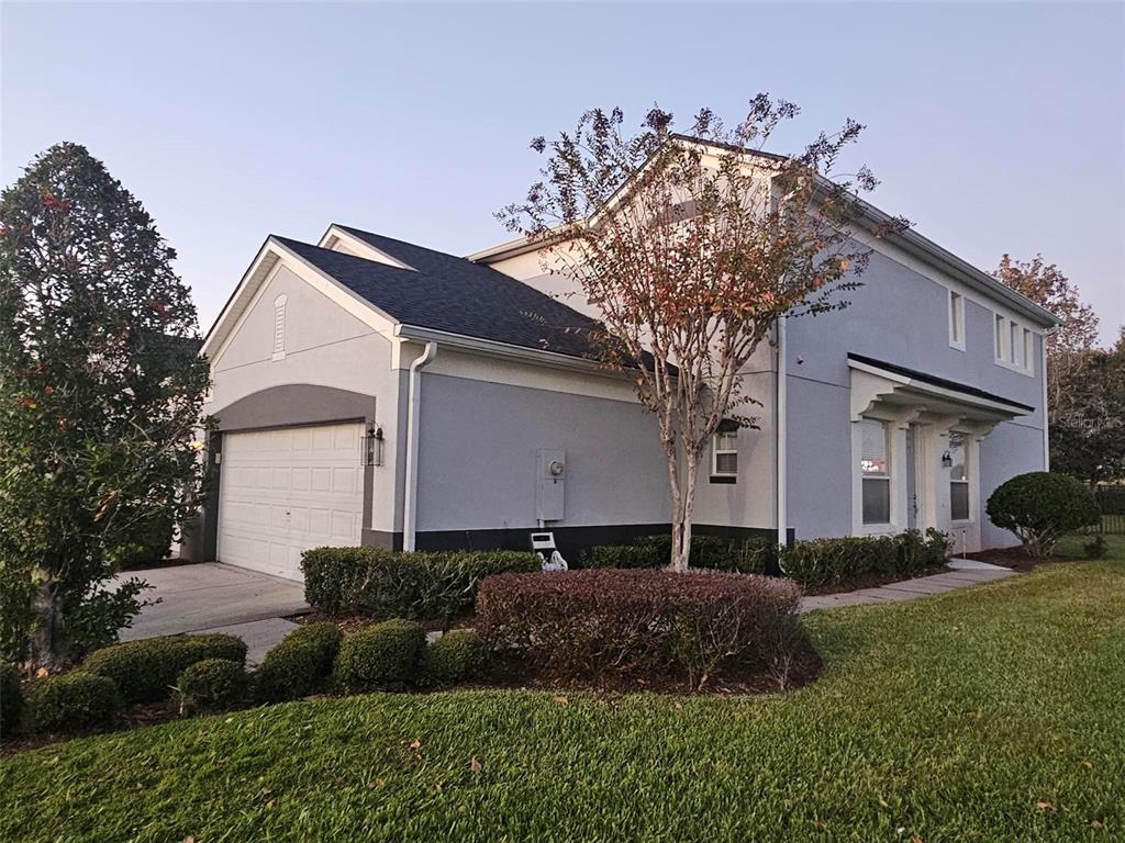 1215 Shallcross Avenue Orlando, FL 32828 - Photo 1 of 44 a front view of a house with a garden