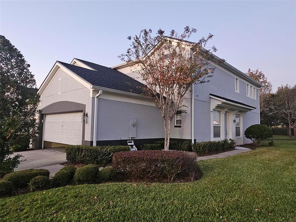 1215 Shallcross Avenue Orlando, FL 32828 - Photo 2 of 44 a front view of a house with a yard and garage