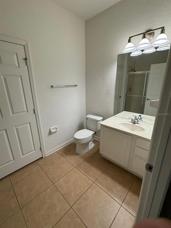 1215 Shallcross Avenue Orlando, FL 32828 - Photo 22 of 44 a bathroom with a sink a toilet and mirror