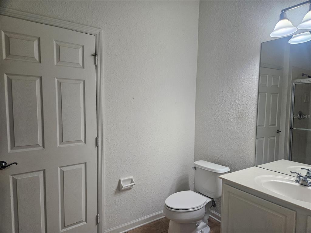 1215 Shallcross Avenue Orlando, FL 32828 - Photo 23 of 44 a white toilet sitting next to a bathroom sink