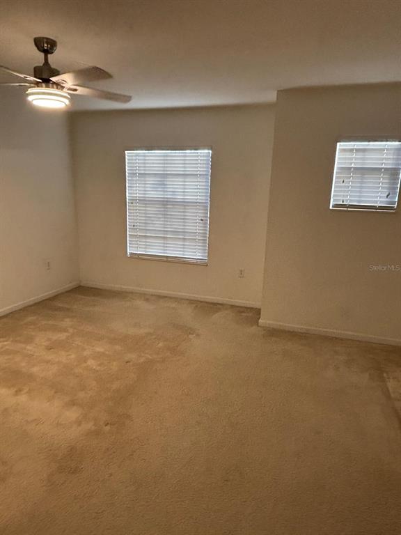 1215 Shallcross Avenue Orlando, FL 32828 - Photo 32 of 44 an empty room with a ceiling fan and window