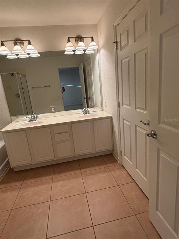 1215 Shallcross Avenue Orlando, FL 32828 - Photo 34 of 44 a bathroom with a sink vanity and mirror