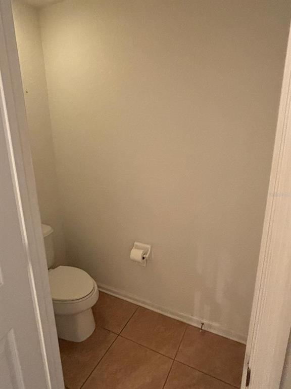 1215 Shallcross Avenue Orlando, FL 32828 - Photo 35 of 44 a white toilet sitting in a bathroom next to a sink