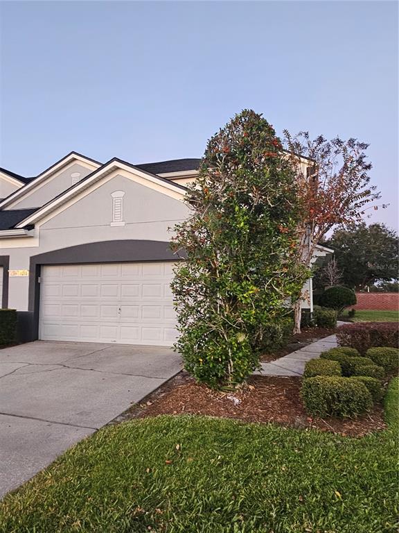 1215 Shallcross Avenue Orlando, FL 32828 - Photo 4 of 44 a front view of a house with a yard and garage