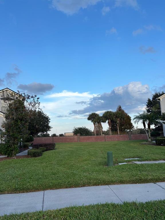 1215 Shallcross Avenue Orlando, FL 32828 - Photo 7 of 44 a view of a grassy field with mountain