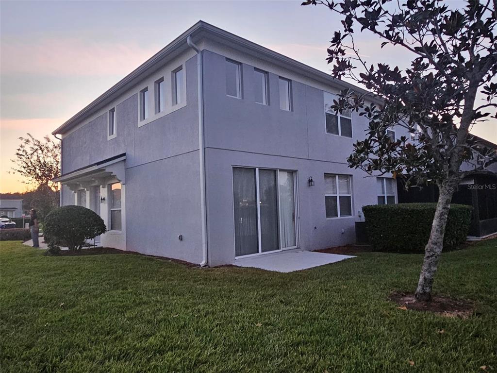 1215 Shallcross Avenue Orlando, FL 32828 - Photo 8 of 44 a view of a house with backyard and a tree