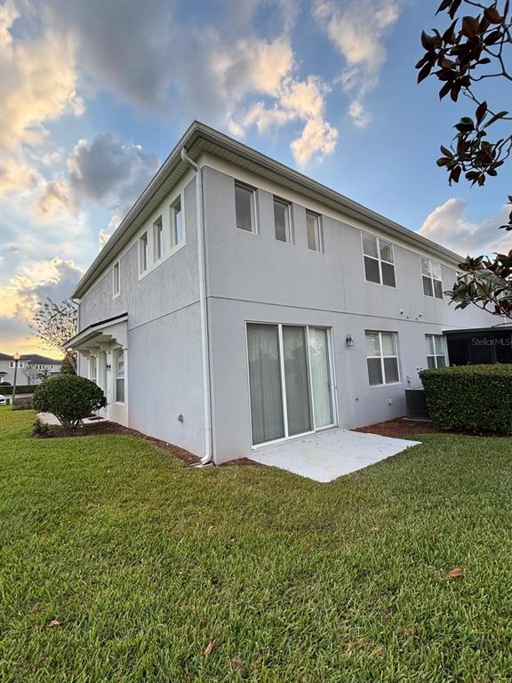 1215 Shallcross Avenue Orlando, FL 32828 - Photo 9 of 44 a front view of a house with a yard and garage